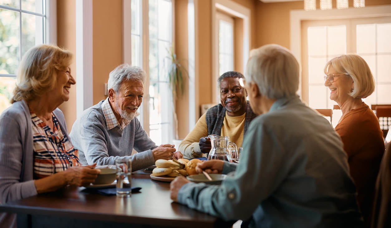 Seniors enjoying the company of and in conversation with friends