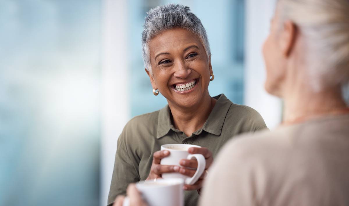 two senior women chatting over coffee